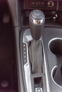 Close-up top view automatic gear stick of a modern car. Automatic transmission in Parking, parked P mode.