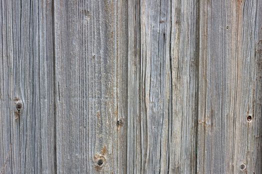 Background of old boards. Wooden old fence close-up. Wood texture