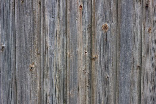Background of old boards. Wooden old fence close-up. Wood texture
