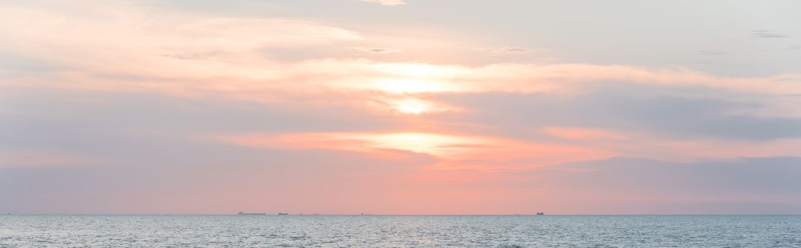 Panorama view scenery sunset on the beach of Melaka, Malaysia. Shipping boat and cruise can seen in the distance