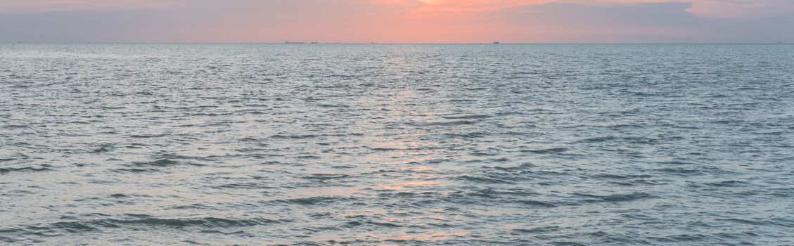 Panorama view scenery sunset on the beach of Melaka, Malaysia. Shipping boat and cruise can seen in the distance