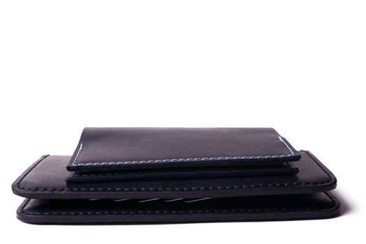 Black handmade leather man wallet and passport cover isolated on white background. Purse and cover are closed. Stock photo of luxury businessman accessories.