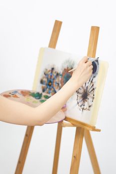 Close up of artist painting on an easel