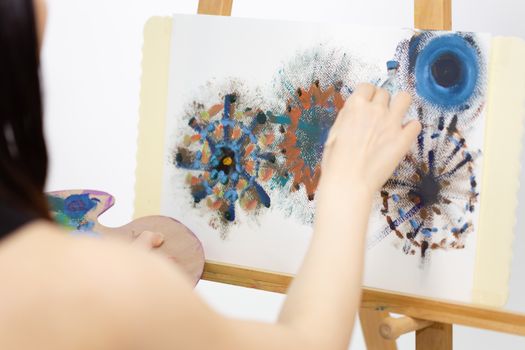 Close up of artist painting on an easel, POV shot