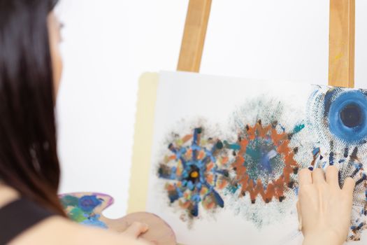 Close up of artist painting on an easel, POV shot