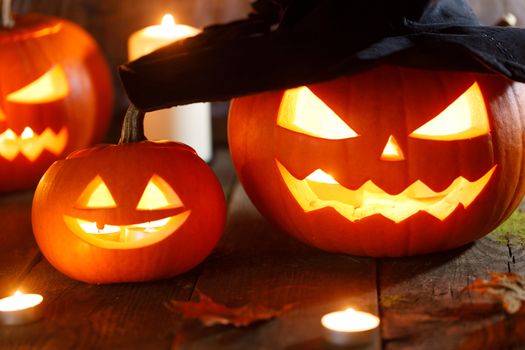 Jack O Lantern Halloween pumpkin with witches hat, spiders on web and burning candles