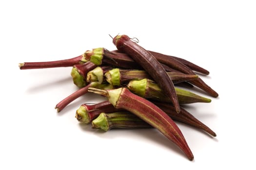 Fresh organic red okra isolated on a white background.