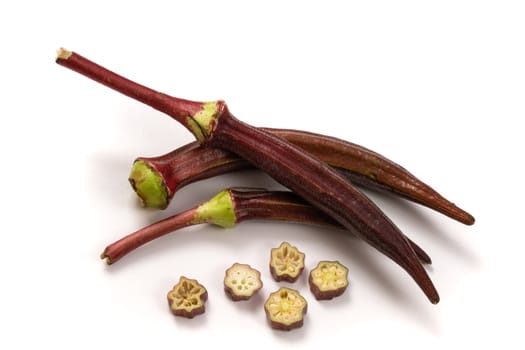 Fresh organic red okra isolated on a white background.