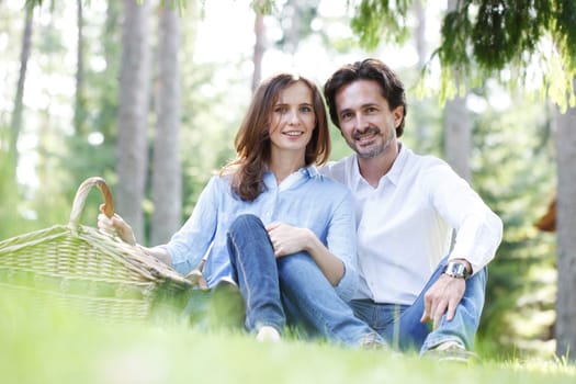 Young beautiful couple on picnic in summer park