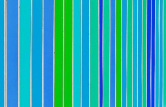 Metal fence rails, painted in different colors. Beautiful colorful background.