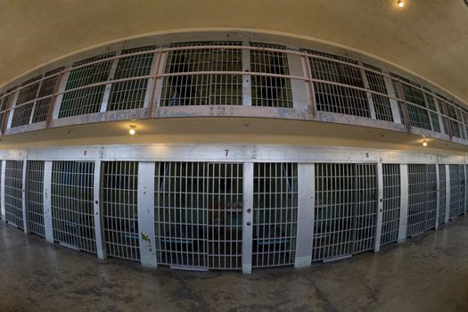 distorted view from a fisheye lens looking at the front of the prison cells