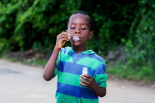 Boy is having fun blowing bubbles.