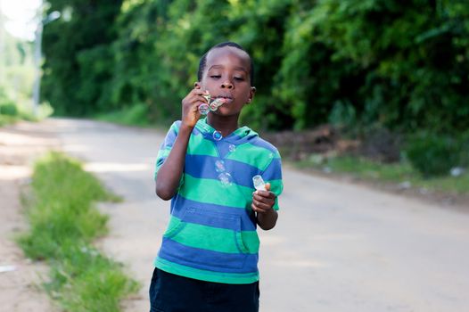 Boy is having fun blowing bubbles.