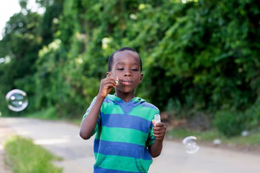 Boy is having fun blowing bubbles.