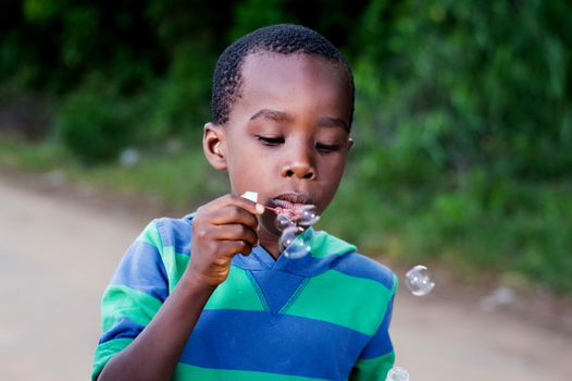Boy is having fun blowing bubbles.
