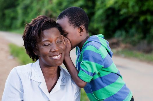 child talking secretly to his mother's ear in campaign 