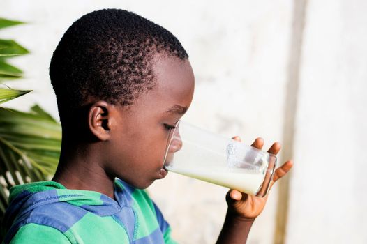boy drinks milk in a glass.