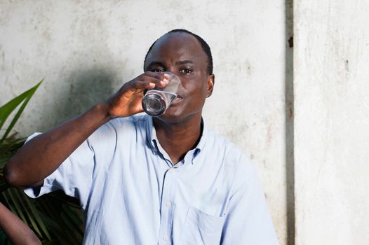 middle-aged man drinking water in a glass