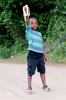 this  boy shows the banana he is eating his parents.