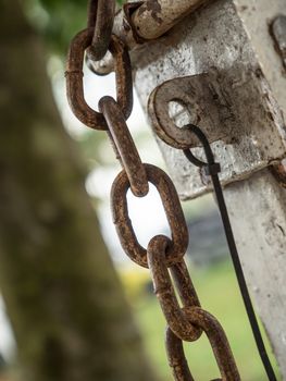 rusty chain and metal lock on the fence gate