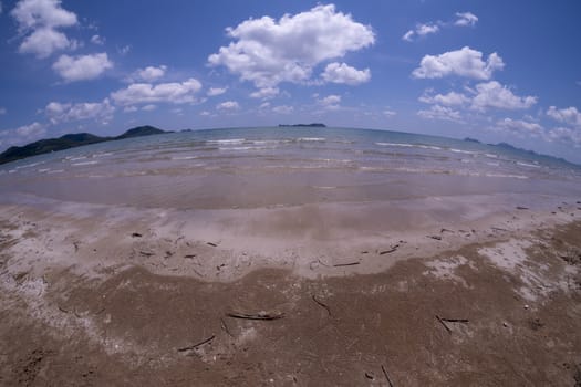 Daytime beach wide angle. Sairee Beach, March 2019. Fluffy white clouds and blue skies.