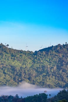 Wind turbine at the mountain and the mist.