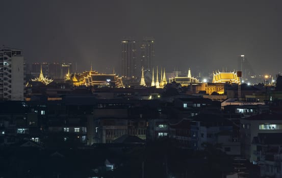 The capital city of Thailand is decorated with bright lights at night. Visible from a distance
