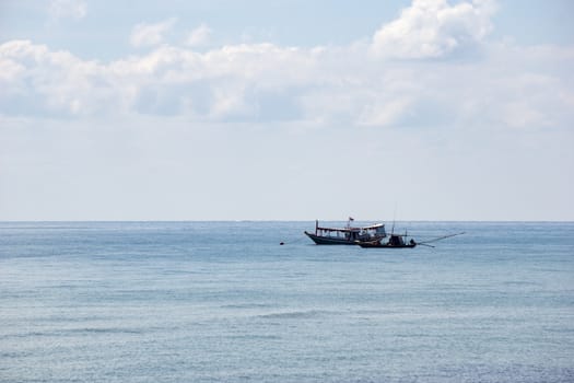 Small boats park by the sea. Small boats near the beach. Sandy beach at Sairee Beach, Chumphon Province