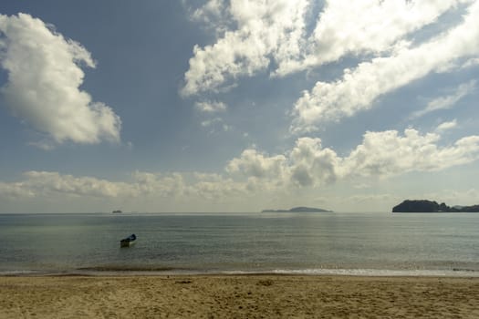 Sea atmosphere at Sairee Beach, Chumphon Province, March 2019.​The sea and the beach at noon. The bright sky, the clouds are white.
