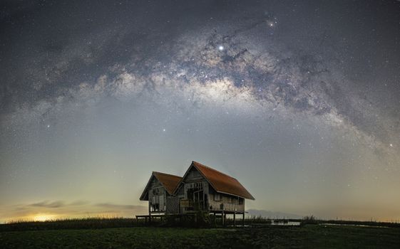 Milky Way panorama, old abandoned house, red roof on open field