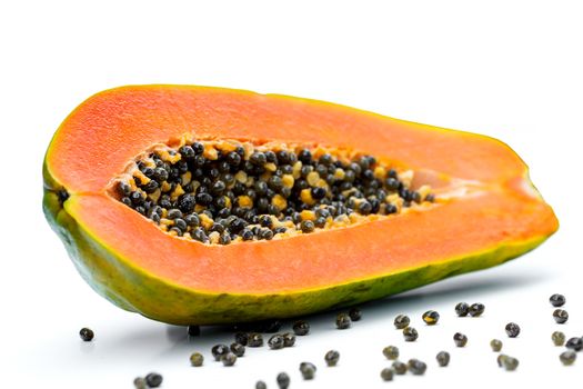 Half sweet papaya fruit with seeds isolated on white background.