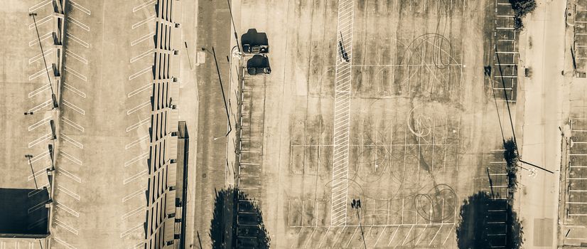 Vintage tone aerial view large empty rooftop parking and ground parking lots with many vacant spaces. Top view transportation infrastructure in downtown Dallas, Texas, USA