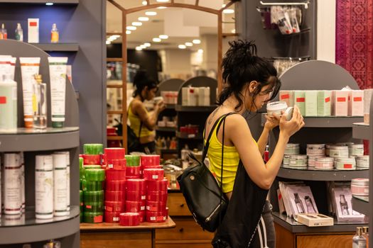 a girl testing cosmetic goods at a store. photo has taken at a cosmetics store.