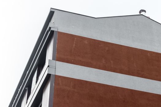 a corner from a modern building with red bricks - white background. photo has taken from izmir/turkey.