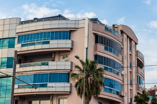 a corner shoot from an modern building with balcony - a palm tree near it. photo has taken at izmir/turkey.