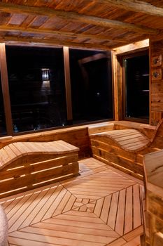 Handmade bath in the spa complex. The bath is trimmed with planks and hay.