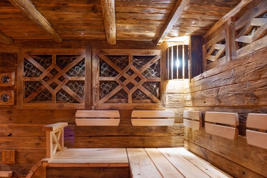 Handmade bath in the spa complex. The bath is trimmed with planks and hay.