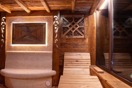 Handmade bath in the spa complex. The bath is trimmed with planks and hay.