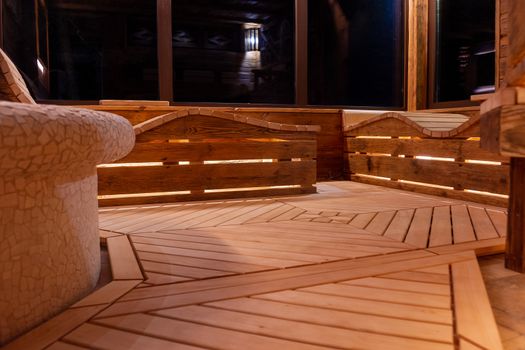 Handmade bath in the spa complex. The bath is trimmed with planks and hay.