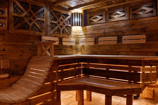 Handmade bath in the spa complex. The bath is trimmed with planks and hay.