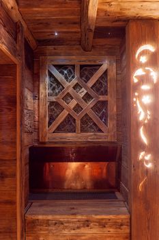 Handmade bath in the spa complex. The bath is trimmed with planks and hay.