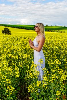 Woman in white dress pray for rain for farming crops and fields from drought