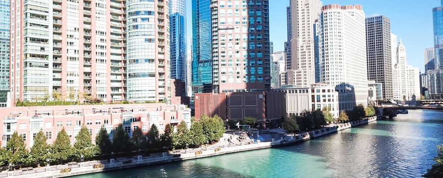 Panorama aerial view riverside skyscraper in downtown Chicago. Modern waterfront commercial and residential buildings, office spaces