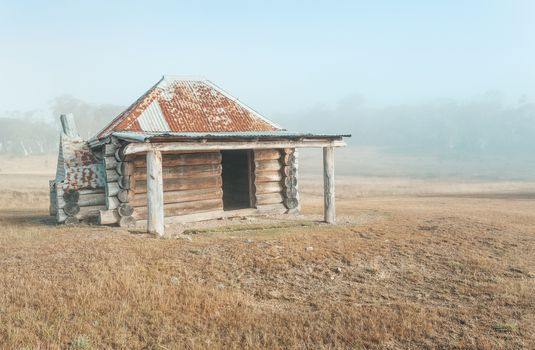 Simple chunky log cabin in the early morning mist.These huts are spread all around and  provided free by the government for use in times of extreme weather