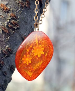 the old pendant with flower in amber