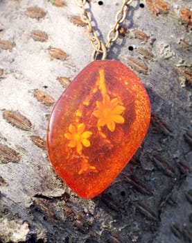 a nice old pendant with flower in amber