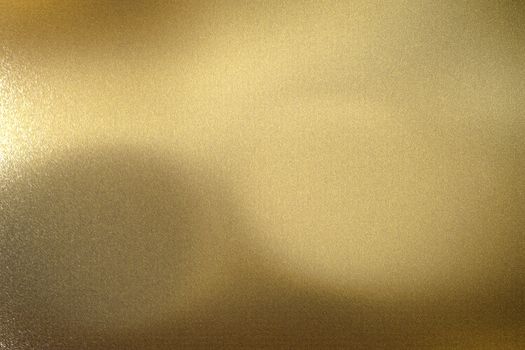 Light shining on gold wave metal panel, abstract texture background