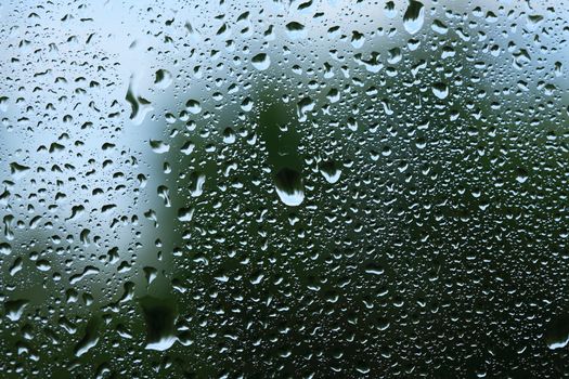 Weather concept. Rain drops on window glass