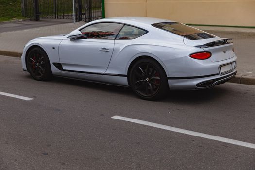 White brand new luxury sport cat Bentley Continental GT 2018 coupe on the streets of European city