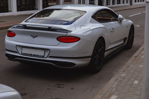 White brand new luxury sport cat Bentley Continental GT 2018 coupe on the streets of European city